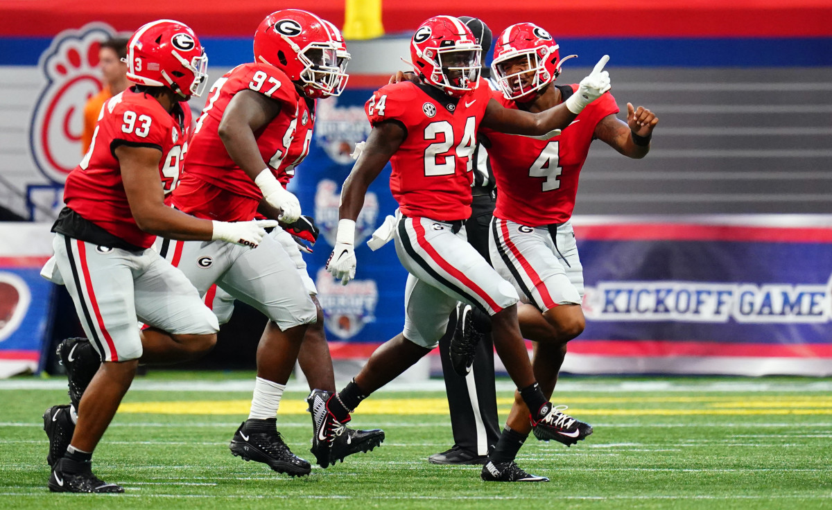 Sep 3, 2022; Atlanta, Georgia, USA; Georgia Bulldogs defensive back Malaki Starks (24) celebrates his interception against Oregon Ducks wide receiver Seven McGee (7) during the first quarter of the Chick-fil-A kickoff game at Mercedes-Benz Stadium. Credit: John David Mercer-USA TODAY Sports